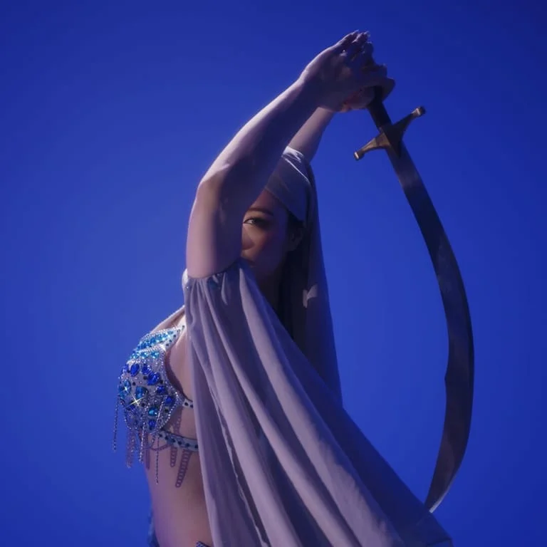 Original blue-lit portrait holding a curved sword